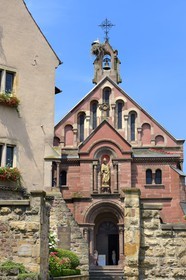 France, Haut Rhin, Eguisheim, labelled Les Plus Beaux Villages de France (The Most Beautiful Villages of France), stork nest on top of the chapel of Leo IX