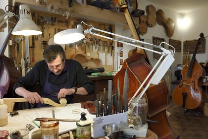 France, Dordogne, White Perigord, Perigueux, the stringed-instrument maker Damien Florio in his workshop from the Rue Aubergerie