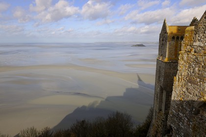 France, Manche, the abbey of Mont Saint Michel, listed as World Heritage by UNESCO, the north buildings (cloister, the knights room) overlooking the bay at low tide