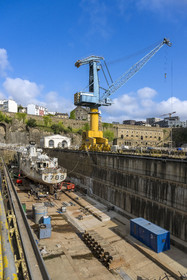 France, Finistère, Brest, the arsenal, the military port is a naval base of the French Navy, warship under construction in one of the two Pontaniou basins located in Pontaniou cove, the Lions building in the background on the right