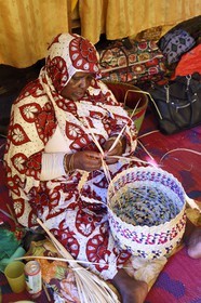 France, Mayotte island (French overseas department), Grande-Terre, Sada, Mahoran women weaving phoenix reclina wild (palm tree) fibers to make baskets at the cooperative
