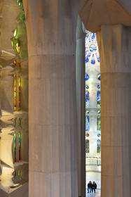 Spain, Catalonia, Barcelona, Eixample district, Sagrada Familia basilica by Catalan modernist architect Antoni Gaudi, listed as a UNESCO World Heritage Site, columns of the central nave and the transept of the Passion facade dedicated to water, resurrection and light in the background