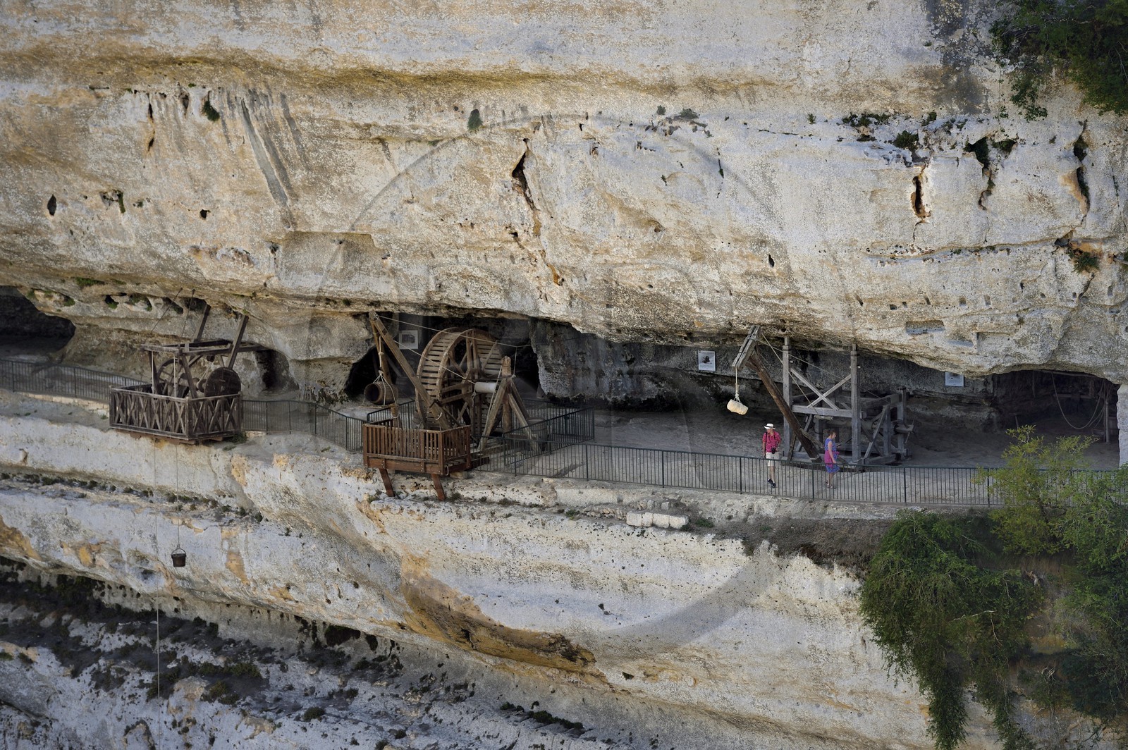France, Dordogne, Perigord Noir, Vezere Valley, prehistoric site and decorated cave listed as World Heritage by UNESCO, Peyzac le Moustier, La Roque Saint Christophe Cliff, troglodytic site dating of the Prehistory, medieval stack machines reconstitution under the rock shelter (aerial view)