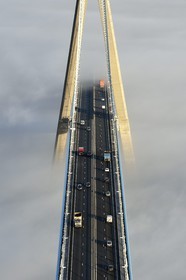 France, between  Calvados and Seine Maritime, the Pont de Normandie (Normandy Bridge) that emerges from the morning mist of autumn and spans the Seine, view from the top of the south pylon