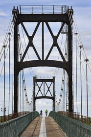 France, Charente-Maritime, Saintonge, Tonnay Charente, cyclists traveling along the Flow Vélo cycle route crossing the suspension bridge built in 1842
