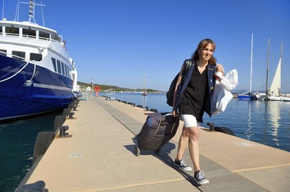 France, Var, Iles d'Hyeres, Parc National de Port Cros (National park of Port Cros), Porquerolles island, arrival of postwoman Christine Frissong at the port early morning with the mail