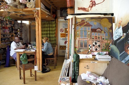 France, Paris, Barthelemy Toguo, the artist founder of Bandjoun Station in Cameroon (shown in the painting right), in his Parisian studio