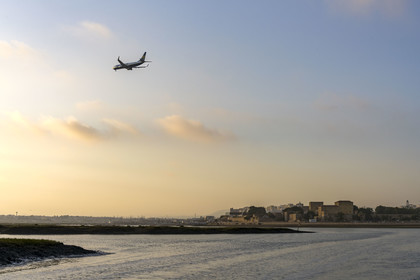 Portugal, Algarve, Faro, Ria Formosa Nature Park, Ryanair airliner landing over the lagoon, the old town in the background