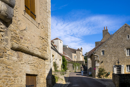 France, Yonne, Montreal (Burgundy), hiker going down the Grand-Rue