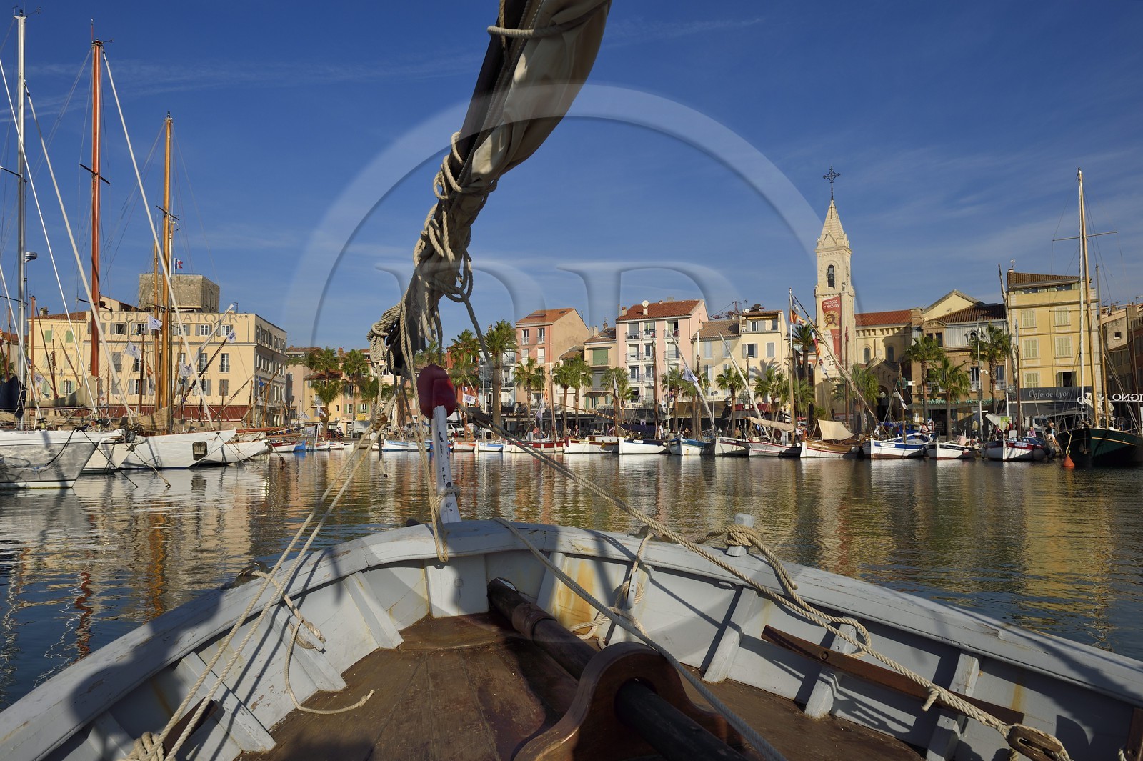 France, Var, Sanary-sur-Mer, traditional fishing boats called pointus in the port and St. Nazaire Church