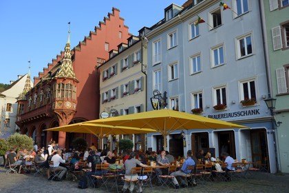 Germany, Baden-Wurttemberg, Freiburg im Breisgau, the Historical Merchants Hall of the early 16th century on the Munsterplatz and Terrace of the restaurant Oberkirch