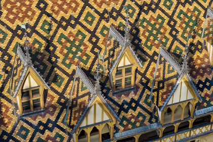 France, Cote d'Or, Beaune, area listed as World Heritage by UNESCO, Hospices de Beaune, Hotel Dieu, the roofs covered with glazed and colored tiles (aerial view)