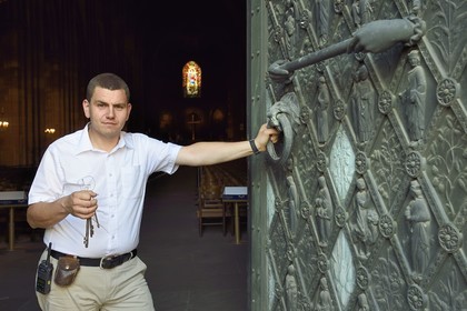 France, Bas Rhin, Strasbourg, old town listed as World Heritage by UNESCO, Notre Dame Cathedral, Sacristan Michel Bolli opens the main door of the Western facade in the early morning