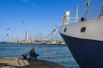 France, Herault, Sete, Fishing port and the mole Saint-Louis lighthouse in the background