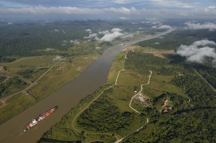 Panama, Panama Canal, a Panamax container cargo uses the Gaillard cut (or Culebra cut) between the Pedro Miguel locks on the Pacific side and the Chagres river leading to Gatun Lake (aerial view)