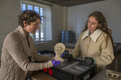 France, Saone et Loire, Autun, Rolin Museum reserves, Agathe Mathiaut-Legros, director of museums and heritage, and assistant curator Axelle Goupy, handling a Gallo-Roman terracotta figurine from a necropolis