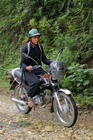 Vietnam, Lao Cai province, Sapa district, man from the Black Hmong minority group on a motorbike
