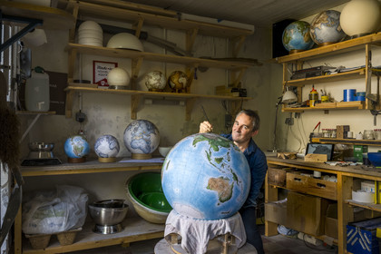 France, Charente, Cognac, Gabriel Gaborel, creator of OrbisTerrae, manufactures handcrafted terrestrial globes painted in watercolor