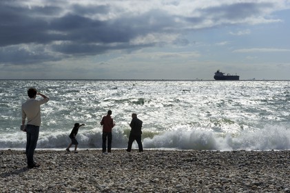 France, Seine Maritime, Le Havre, cargo leaving the port seen from the city beach