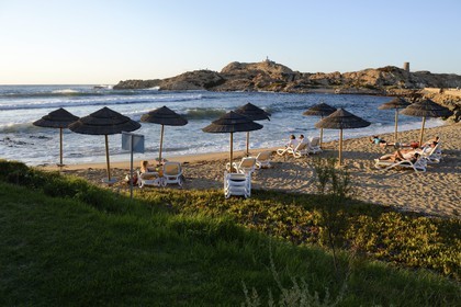 France, Haute Corse, Balagne, L'Ile Rousse, the Pietra Lighthouse and the fifteenth century Genoese tower behind the beach