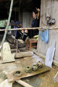 Vietnam, Lao Cai province, Sapa district, woman from the Black Hmong minority group in her weaving workshop