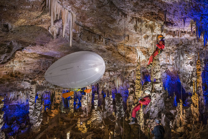 France, Gard, Mejannes-le-Clap, grotte de La Salamandre (Salamander cave), abseiling and discovery of the cave in Aéroplume®, an individual dirigible balloon inflated with helium which allows you to fly away by flapping your wings