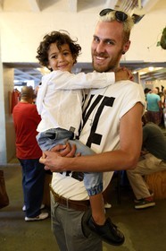 South Africa, Gauteng Province, Johannesburg, Braamfontein district, Neighbourgoods Market on saturdays is as much a source for farm fresh foods and specialty goods as it is a meeting point to enjoy community, swop ideas and stories, and be inspired by the energy that makes Joburg, father and son