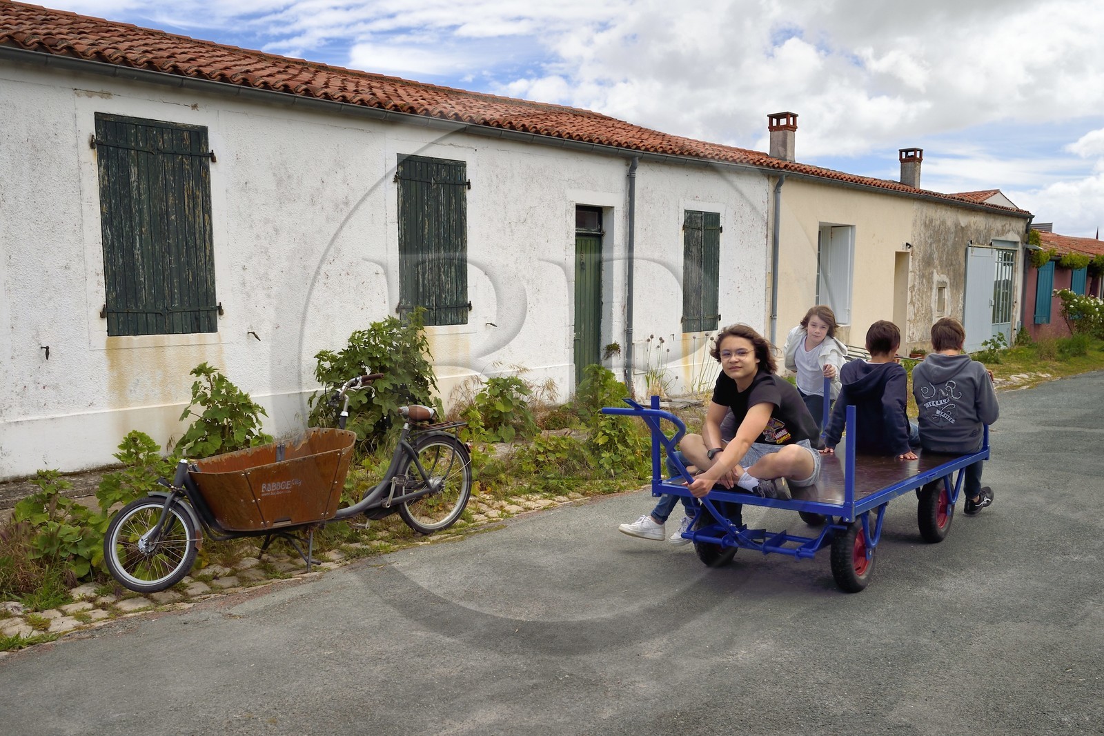 France, Charente-Maritime (17), Ile d'Aix, le bourg, jeux d'enfants sur un chariot dans la rue Marengo France, Charente-Maritime (17), Ile d'Aix, le bourg, jeux d'enfants sur un chariot dans la rue Marengo