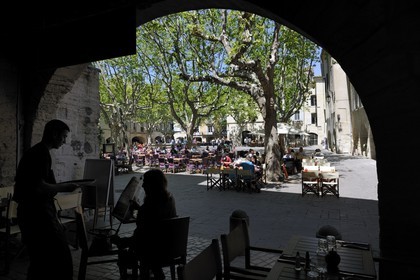 France, Gard, Uzes, listed as town of art and history, the Place aux Herbes surrounded by arcaded houses and its outdoor cafes