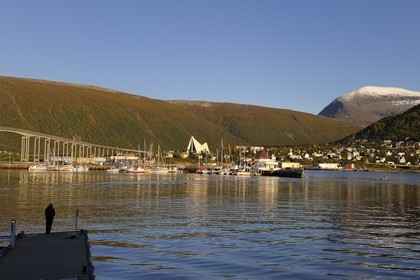 Norway, Troms County, Tromso harbour in Tromsesundet Fjord, the Arctic Cathedral and Tromsdalstind Mount (1238 m) in the background