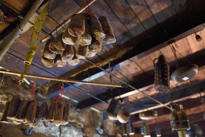 France, Corse du Sud, Sartene, the Oasis du Lion Inn à Roccapina, meats hanging from the ceiling