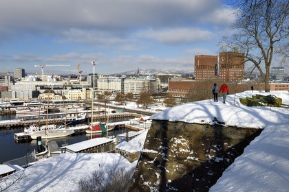 Norway, Oslo, the port and the city hall (Radhuset) seen from the ramparts of the Akershus Fortress under the snow