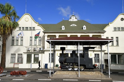 Namibia, Khomas region, Windhoek, the colonial Cape Dutch-style architecture railway station in Bahnhof strasse dating back to the German era, one half of an original back-to-back twin locomotive in use between 1904 and 1915 called Poor Old Joe in the foreground