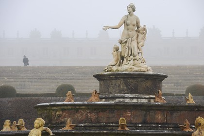 France, Yvelines, parc du Chateau de Versailles, listed as World Heritage by UNESCO, statue of the Latona Basin in the Winter mist