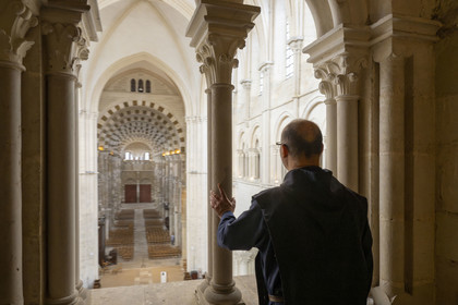 France, Yonne, regional natural park of Morvan, Vézelay, a UNESCO World Heritage site, labelled Les Plus Beaux Villages de France, starting point of one of the main ways to Santiago de Compostela, the Basilica of Saint Mary Magdalene, Brother Matteo of the Jerusalem Fraternity in black tunic and chasuble in the triforium overlooking the choir
