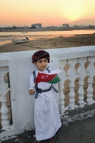 Sultanate of Oman, Ash Sharqiyah South Governorate, city and harbour of Sur, the old fishing quarter of Al Ayjah, Jassin, young Omani in traditional dress on the occasion of the national holiday of November 18