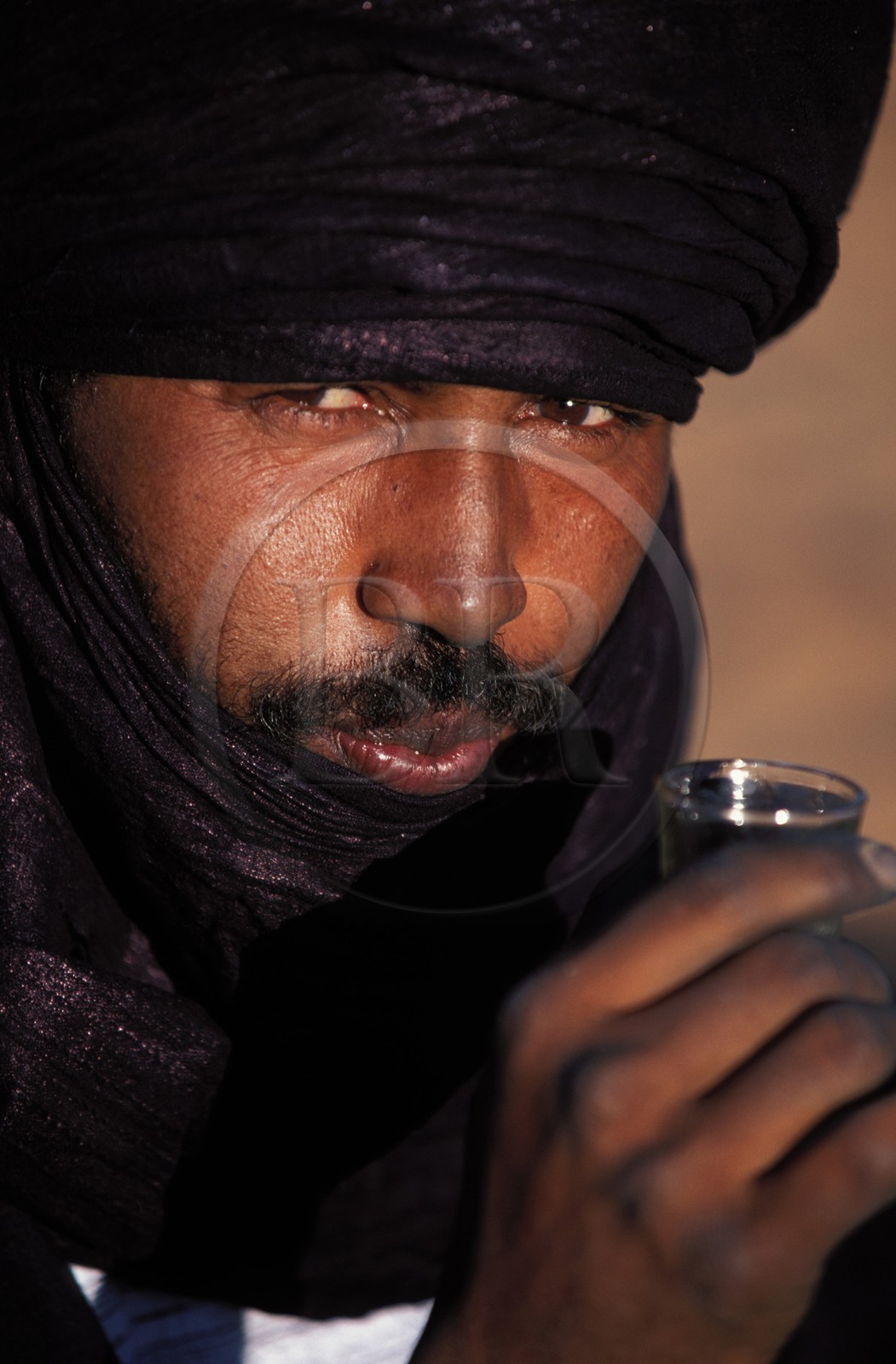 Libye, région du désert, Le Fezzan (Sahara), un touareg en costume traditionnel boit un thé à la menthe