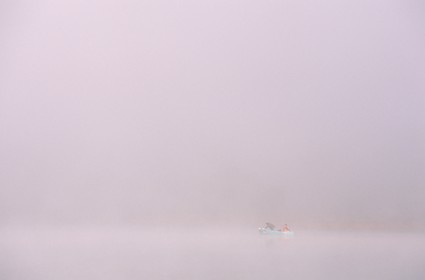 France, Doubs, fishermen on the Saint Point lake in the early morning mist