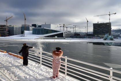 Norway, Oslo, the Opera under the snow, designed by the architecture firm Snohetta (including Tarald Lundevall) on the commercial and industrial port of Bjorvika district undergoing restructuring
