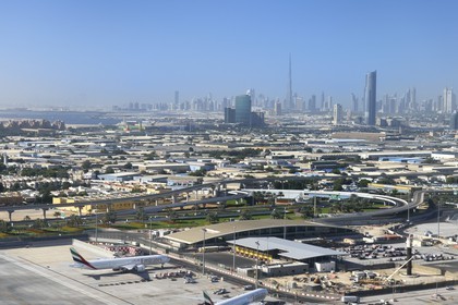 United Arab Emirates, Dubai, Dubai International Airport and the city center in the background (aerial view)
