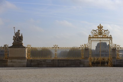 France, Yvelines, Chateau de Versailles, listed as World Heritage by UNESCO, The Peace statue by Jean Baptiste Tuby and the Royal Gate drawn by Mansart (restored in June 2008) which separating the Royal Courtyard