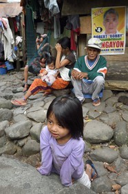 Philippines, Ifugao province, Banaue region, village of Cambulo, little girl in front of the family home