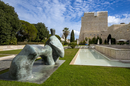 Portugal, Lisbon, Belem, Belem Cultural Centre MAC CCB by architects Vittorio Gregotti and Manuel Salgado, Reclining Figure: Arched Leg (1969) by artist Henry Moore in the foreground