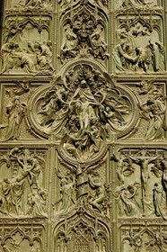 Italy, Lombardy, Milan, the Duomo in the historical center, cathedral in Gothic Flamboyant style, central portal, bronze door which tells the story of Mary's life (drawings by Ludovico Pogliaghi)