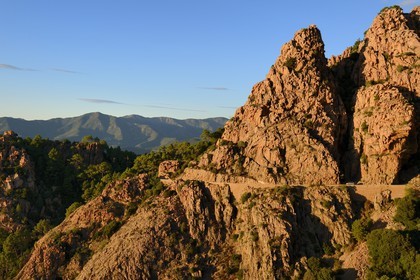 France, Corse du Sud, Golfe de Porto, listed as World Heritage by UNESCO,  the Creeks of Piana (Calanches de Piana) with pink granite rocks and the D81 road between Porto and Cargese