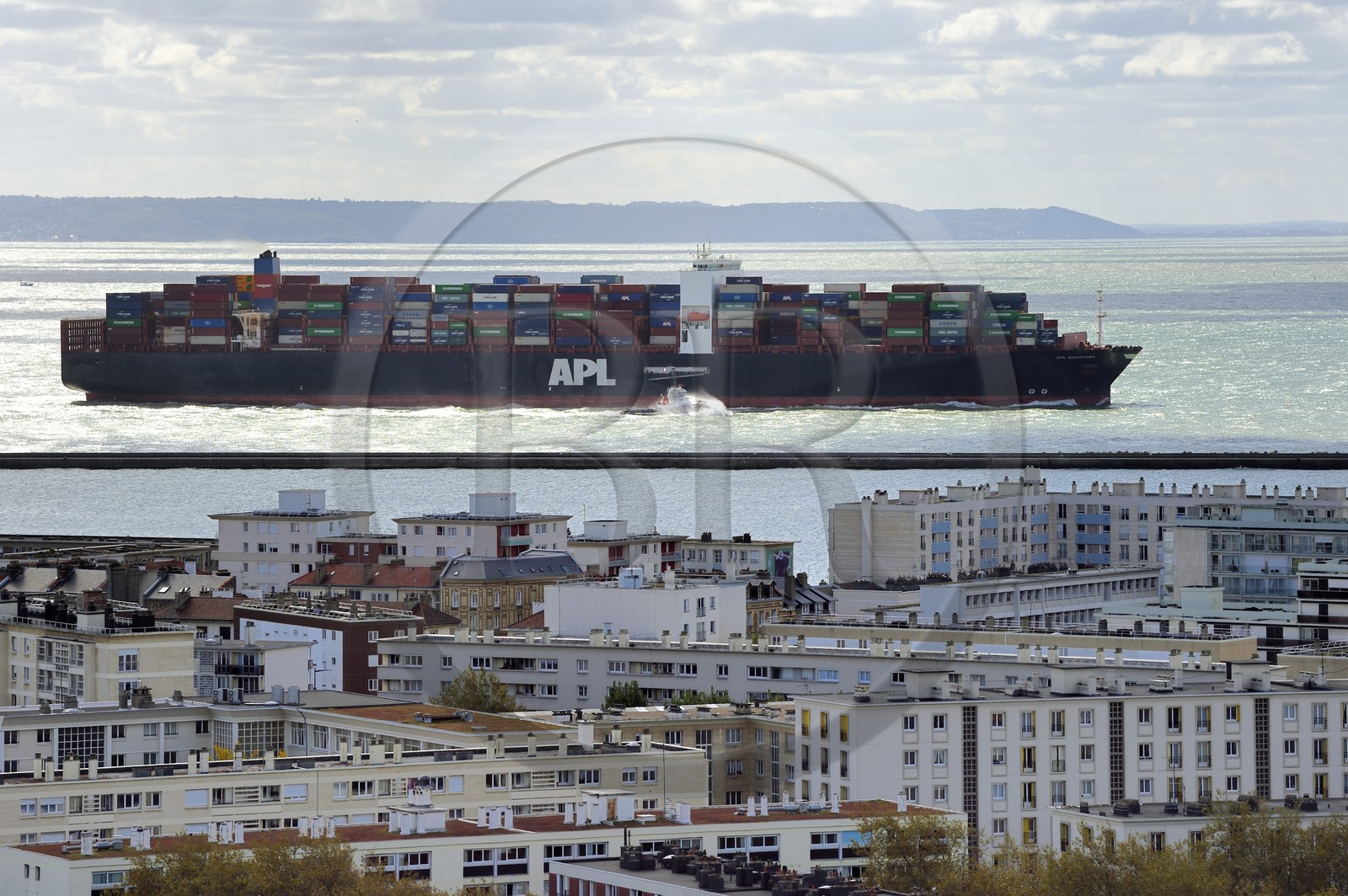 France, Seine Maritime, Le Havre, a container ship leaves the commercial port and seems to follow the buildings