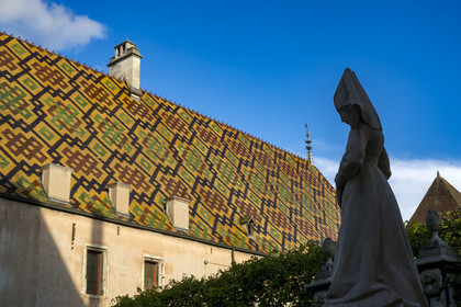 France, Cote d'Or, Beaune, area listed as World Heritage by UNESCO, Hospices de Beaune, Hotel Dieu, Founders' Courtyard, statue of Guigone de Salins who created the hospices with her husband Nicolas Rolin