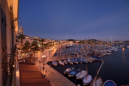 France, Var, Sanary-sur-Mer, traditional fishing boats called pointus in the port and St. Nazaire Church
