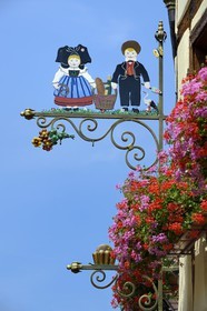 France, Haut Rhin, Eguisheim, labelled Les Plus Beaux Villages de France (The Most Beautiful Villages of France), baker sign with characters in typical outfit from Alsace