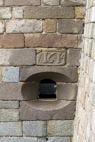 France, Finistère, Morlaix bay, Plouezoc'h, the Taureau castle built by Vauban in the 17th century, cannon muzzle and stone dated from the construction